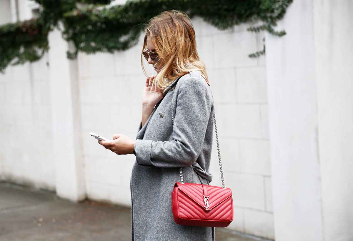 blogger on street on phone with ysl red bag
