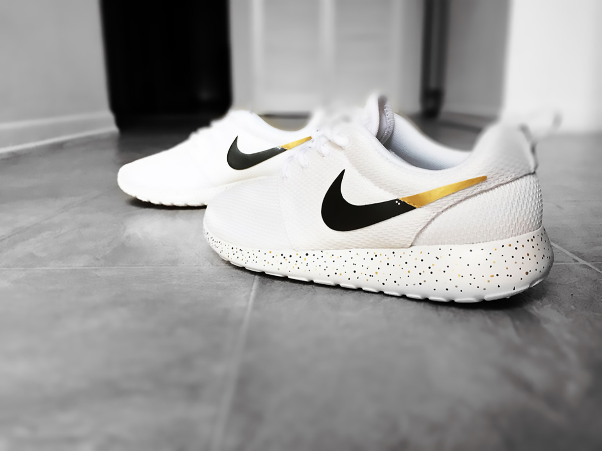 gold and white roshe nike sneakers