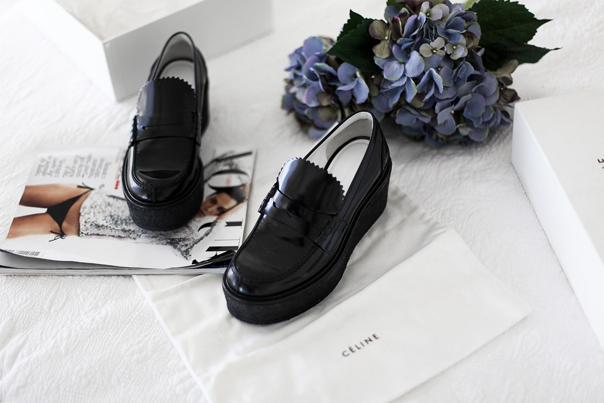 Style blogger Lisa Hamilton styles Celine black platform loafers from Yoox online store