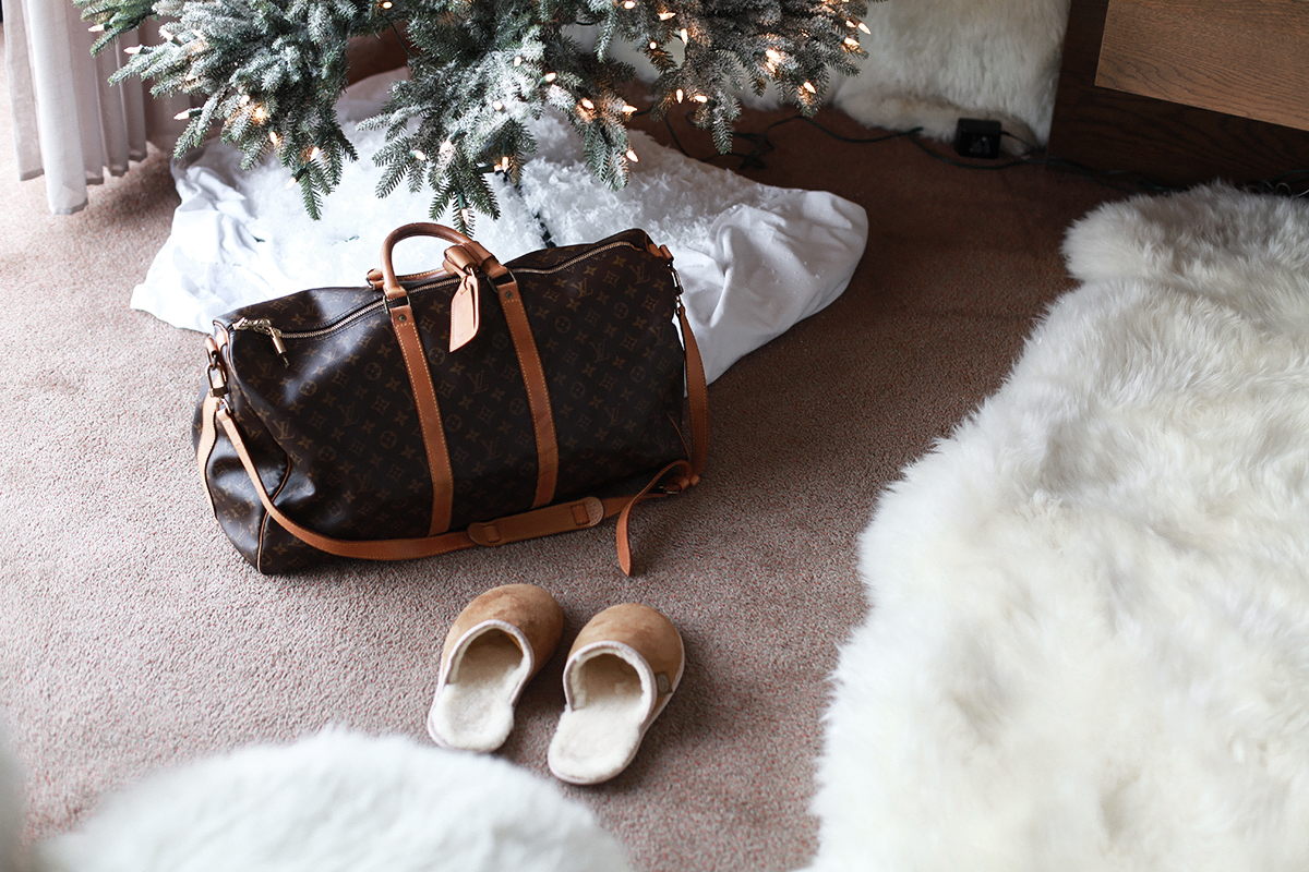 Lifestyle blogger Lisa Hamilton from See Want Shop shows a Louis Vuitton travel bag under the Christmas tree & explains why it's important to start your Christmas shopping now