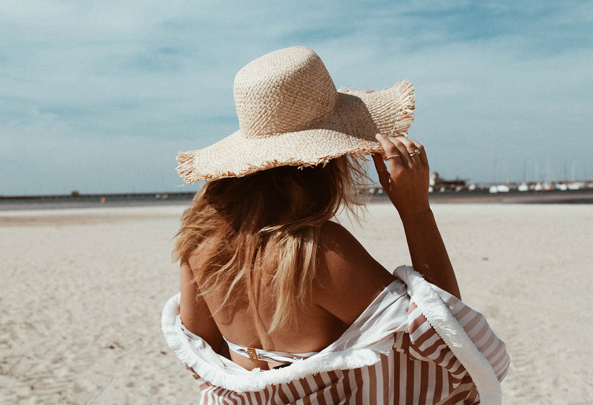 straw hat from Etsy at the beach